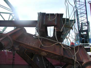 Photo 5. The pile cap hung by the test chains after it broke apart from the W36 I-beams.