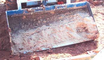 Figure 2. Skid-steer loader bucket of sand.