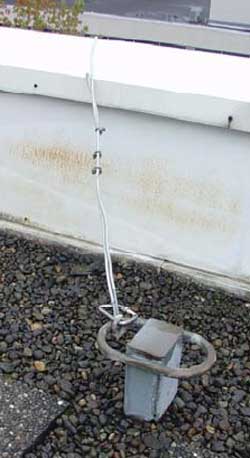 The one secured anchor line dangled over the roof edge following the incident.