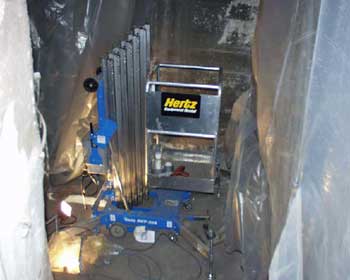 Attachment 2. Genie 30’ Single Person Electric Platform Lift being used on site.
