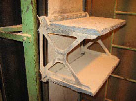 A close-up view of a platform step on the manlift shows the metal framework on the left and emergency ladder on the right.