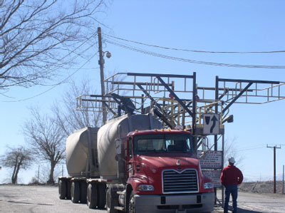 tanker truck accessing tank lid from catwalk