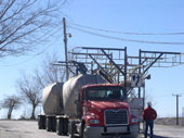 tanker truck accessing tank lid from catwalk