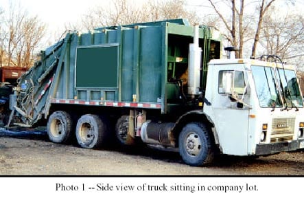 Photo 1 - Side view of truck sitting in company lot.