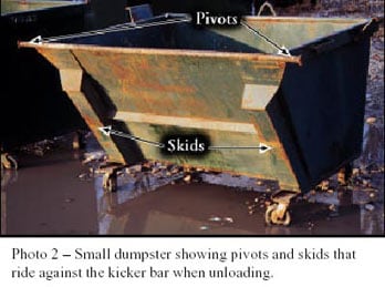 Photo 2 - Small dumpster showing pivots and skids that ride against the kicker bar when unloading.