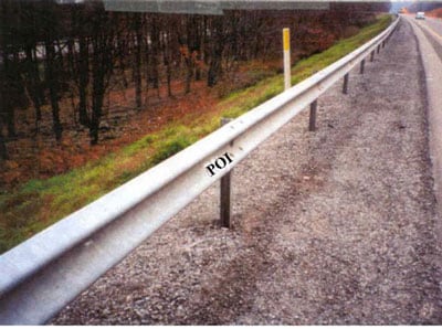 Guardrail on South Shoulder of Westbound Lane. Guardrail is marked POI to designate the apparent point of impact with victim.