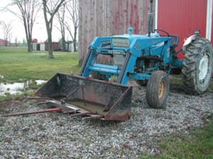 Figure 8. Bale spear attachment to loader bucket