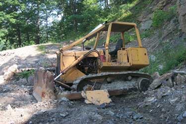 Picture of bulldozer in the mountainside after incident occurred.