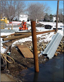 Photo 2. Piles: steel pipe pile in water, sheet pile to right