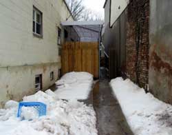 Photo 1. Driveway between two buildings. Incident occurred behind the new fence.