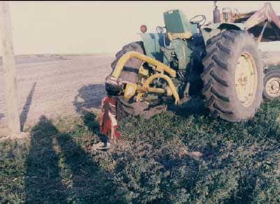 Tractor with posthole digger attachment