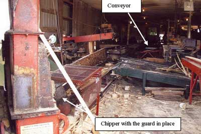 Figure 1. The conveyor transports waste  		  wood to the chipper.