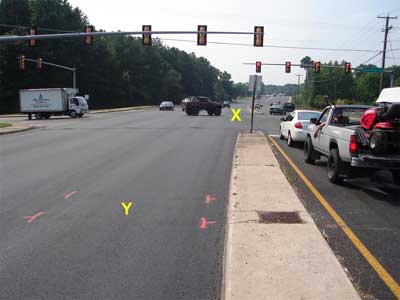View facing east towards intersection and turn lane where paver was being re-positioned.