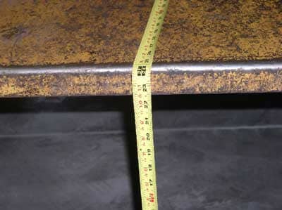 tape measure showing 24 inches from chute to ground