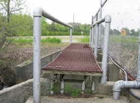 Water level control structure’s wood and expanded metal walkway, handrails, and fence, looking south.