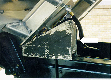 photo shows metal wedge-shaped alternative after-market body prop in place under truck body