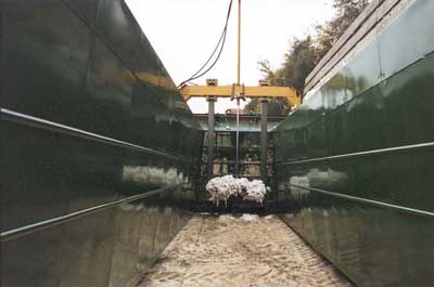 Hydraulically Actuated Tamper Used to Compress Cotton Against the Ground