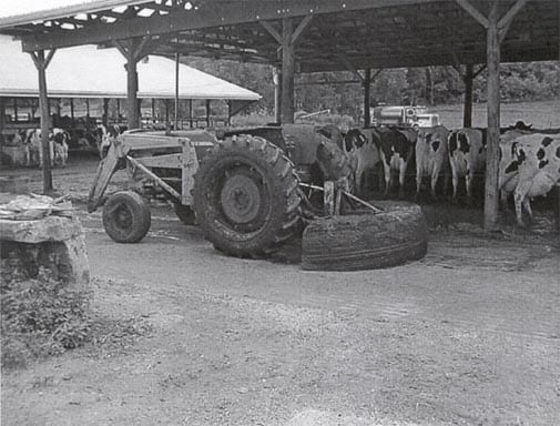 view of tractor with fabricated manure scraper