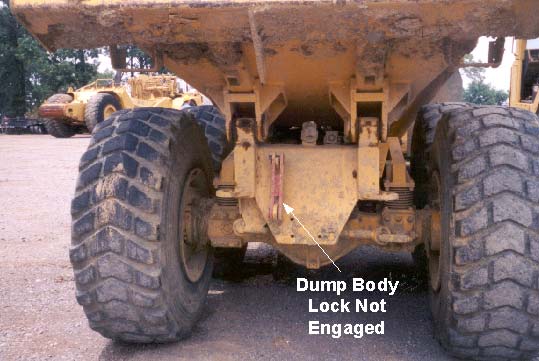 Dump body lock illustrating position of dump body lock when dump body is in lowered position and dump body lock not engaged.