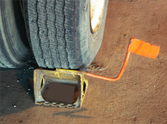 Illustration of a wheel chock with a flag. Metal flag welded onto a metal chock could allow for greater visibility.