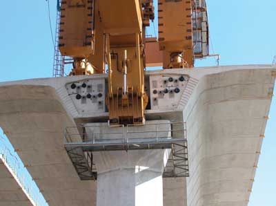 Pre-cast bridge segments in place at end of completed roadbed. Shows rear legs and underbridge of LG1.