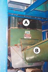 Power unit for augers. Sweep auger axle: cover plate removed and placed below the opening. Pipe enclosing transfer unloader auger.