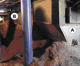 Sweep and transfer unloader auger power unit. Transfer unloader auger, top plates removed, loaded with sawdust.