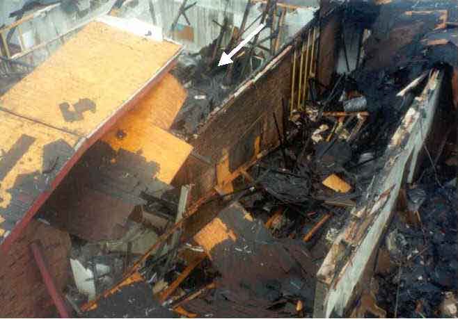 Close- up photograph of the collapsed area of the burned structure.