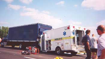 Photo 1. Ambulance was pushed into rear of straight truck during the crash.