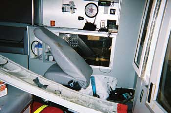 Photo 4. Attendant's seat after crash; note intrusion of drive shaft into compartment