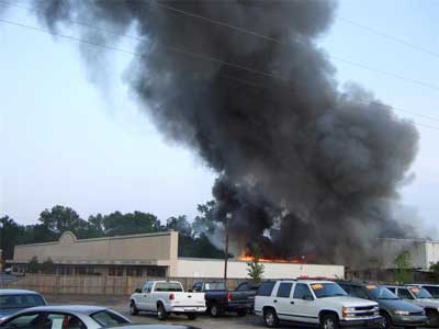 Heavy smoke pouring from the top of furniture store