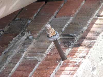bolt on the back of brick facade