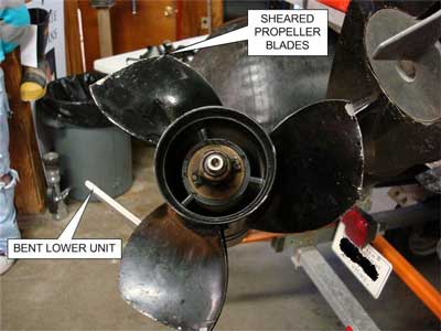 Sheared Propeller  Blades and bent lower unit.