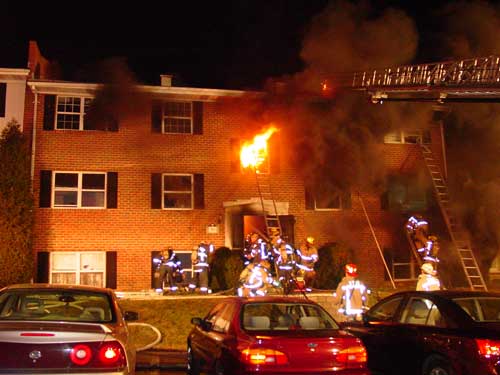 fire fighters and burning building