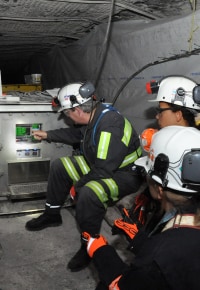 NIOSH researchers using prototype through-the-earth communication system in a coal mine