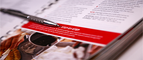 Pen laying on a booklet showing step by step instructions