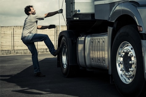 man stepping into a truck
