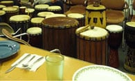Drums in an event room of a community organization building before a meal and drumming circle event.