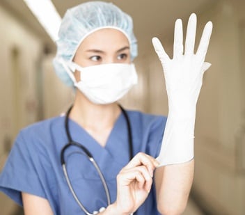 medical putting on gloves