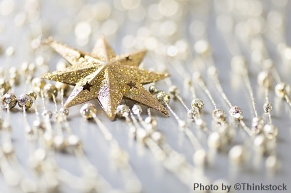 A golden glittered star ornament with smaller surrounding ornaments