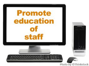 Hands typing on a computer with a banner over the photo that says Promote education of staff