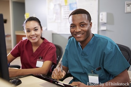 A male and female nurse smiling