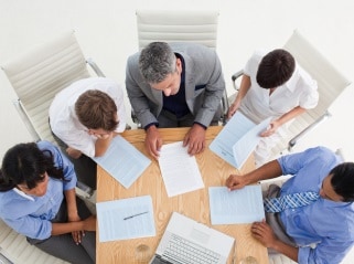 Group of 5 people having a meeting.