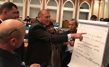 Experts from participating ministries work together to identify criteria used to define the national importance of zoonotic diseases during the OHZDP  Workshop. Photo credit: Tory Seffren