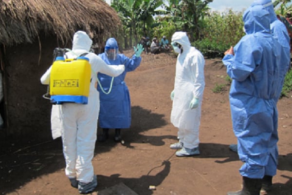 medical personel in protective uniforms in a small village in Afrika