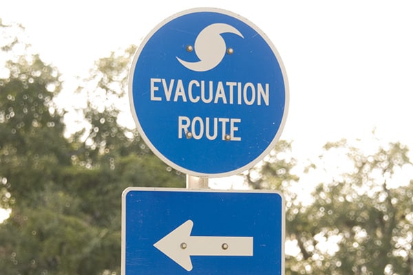 round blue sign that has text Evacuation Route