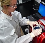 A CDC researcher places samples into a real-time PCR (polymerase chain reaction) machine.