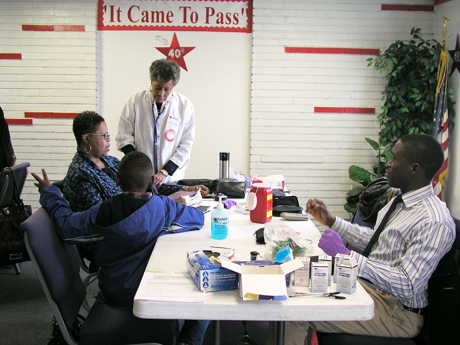 A volunteer nurse provides health information to a Body and Soul Program participant at a church kick-off event. 