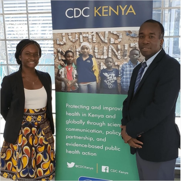 AdeSubomi Adeyemo, Class of 2017 Presidential Management Fellow standing next to CDC Kenya sign.