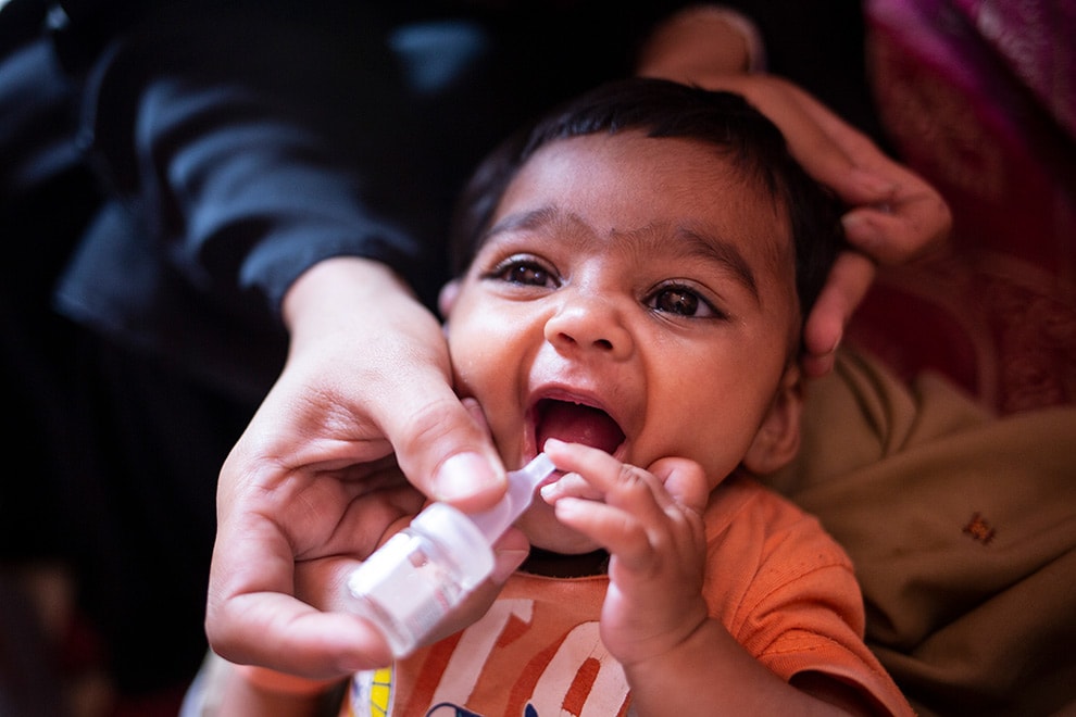 An infant is given oral polio vaccine.